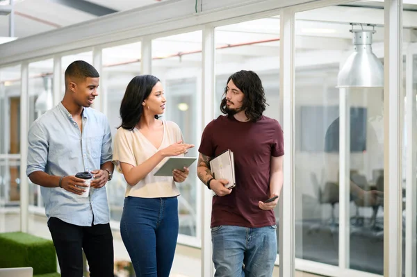 stock image I think you should handle that part of the project. a group of businesspeople having a discussion while walking through an office together