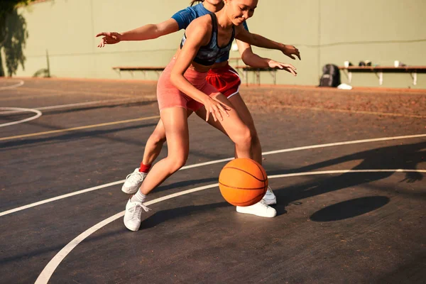 stock image Shes putting me under pressure. an attractive young sportswoman blocking her opponent during a basketball game during the day