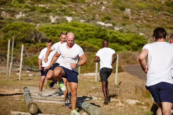 Stock image This is not the time for slacking. a group of men doing drills at a military bootcamp