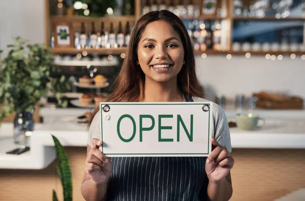 Happy woman, open sign and portrait at cafe of small business owner or waitress for morning or ready to serve. Female person or restaurant server holding board for coffee shop or cafeteria opening.
