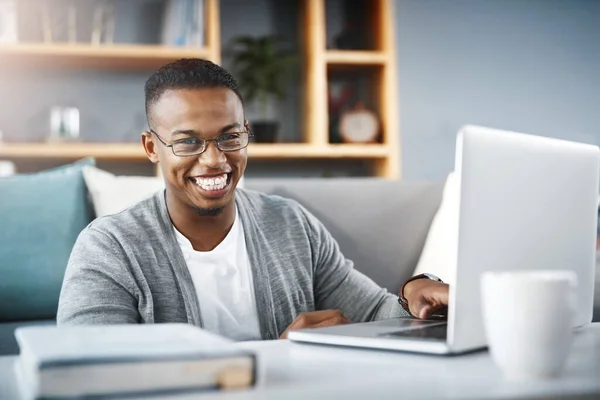 stock image Laptop, home and portrait of man or student with e learning, university online course or college studying in living room. Happy, excited and young african person on computer for scholarship research.