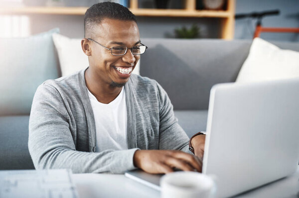 Laptop, home and African man or student elearning, online course and college or university application or typing in living room. Happy african person on computer for education or scholarship research.