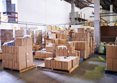 Built for boxes. stacked boxes in a large distribution warehouse clipart