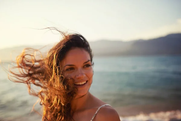 stock image Ocean air. a beautiful young woman on the beach