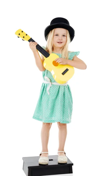 ファンのためにやってるんだ スタジオショットの可愛いです女の子遊びとともに彼女のおもちゃのギターのために白い背景 — ストック写真