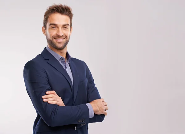 stock image Portrait of confident business man, arms crossed in a suit with smile isolated on studio background. Professional mindset, career success and mockup space with corporate male employee and pride.