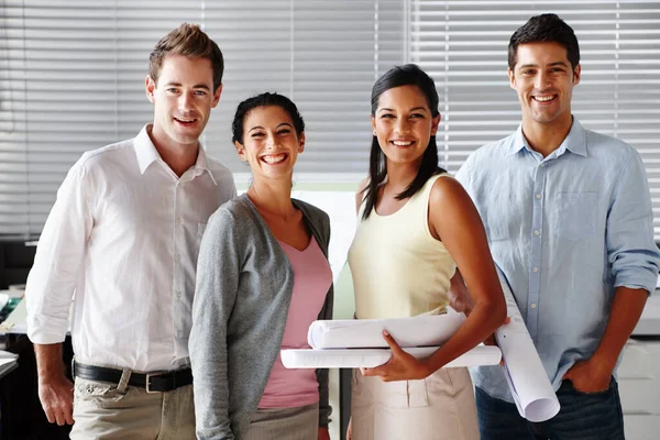 stock image Enthusiastic architects. A confident team of architects smiling at you while holding blueprints