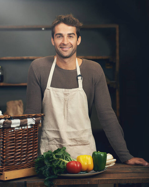 Chef, smile and portrait of man in kitchen with vegetables for vegetarian meal, healthy diet or vegan nutrition. Cooking, happiness and confident male cook from Canada in restaurant or small business.