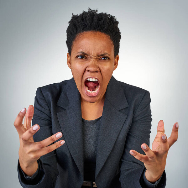 Anger, frustrated and portrait of black woman in studio for screaming, problem and crazy. Mental health, rage and angry with face of female model on gray background for shouting, stress and upset.