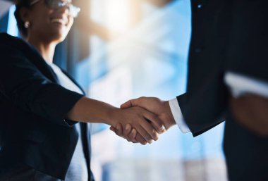 Ready to double up on their success. Closeup shot of two unrecognizable businesspeople shaking hands in an office clipart