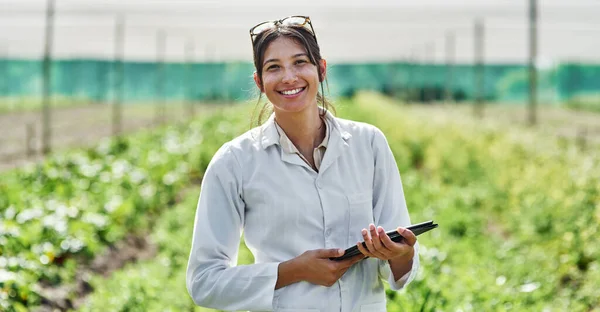 stock image Portrait, tablet and agriculture with a woman in a greenhouse on a farm for organic sustainability. Food, spring and a female farmer outdoor to manage fresh vegetables or produce crops for harvest.