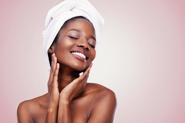 Healthy skin is a beautiful thing. Studio shot of a beautiful young woman wearing a towel on her head