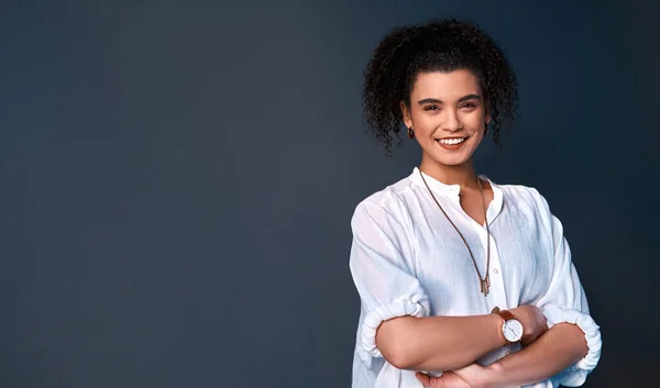 stock image I go after my dreams and aspirations. Cropped portrait of an attractive young businesswoman standing against a gray background alone with her arms folded