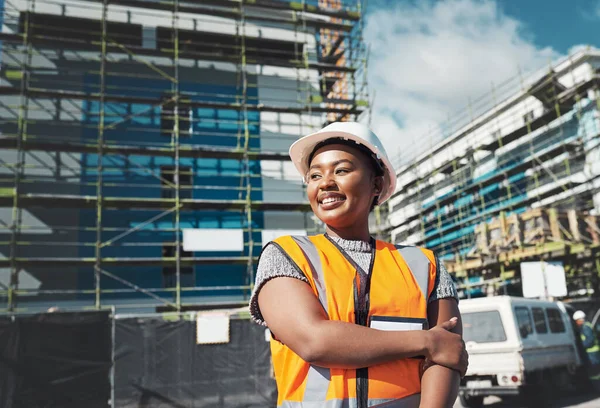 Engineer, construction and a black woman thinking outdoor at building site for development and architecture. Female contractor happy for project management, engineering and equal opportunity in city.