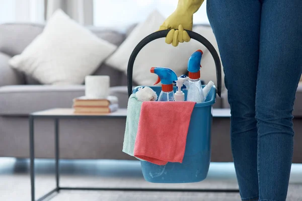 Chores, product and hands with a bucket for cleaning, cleaner lifestyle and home routine. Housework, apartment and person holding equipment to clean a house for housekeeping and hygiene in the lounge.