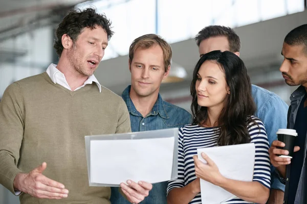 Talking Report Team Group Coworkers Reading Paperwork Together While Standing — Stock Photo, Image