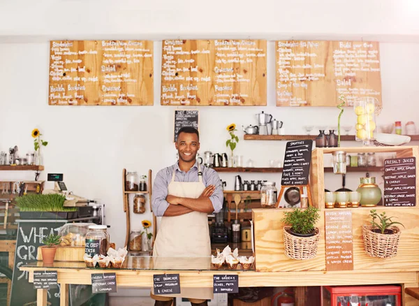 Black man, portrait and owner with arms crossed in cafe with pride for career or job. Barista, smile and confidence of African person from Nigeria in restaurant, small business and coffee shop