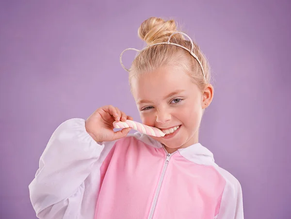 Mmm, marshmallows are the best. A cute little blonde girl dressed as a bear while against a purple background