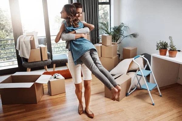 Theyre excited for the future. Full length shot of an attractive young woman and her daughter dancing while moving into their new home