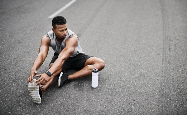 Αποφασιστικότητά Του Είναι Σταθερή Ένας Αθλητικός Νεαρός Που Τεντώνει Πόδια — Φωτογραφία Αρχείου