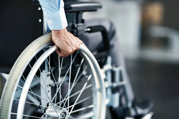 stock image Wheelchair, disability and man hand holding wheel in a hospital for healthcare. Disabled, mobility problem and male person in a clinic for support and medical care with hands of patient and mockup.