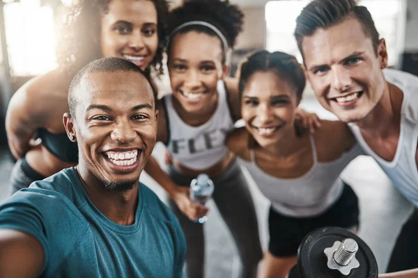 stock image Celebrate a gym session with a selfie. a group of young people taking a selfie together during their workout in a gym