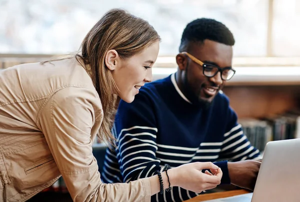 stock image We always help where we can. two university students working together on a laptop at campus