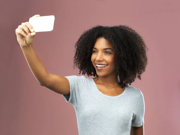 stock image Be true to your selfie. Studio shot of an attractive young woman taking a selfie against a pink background