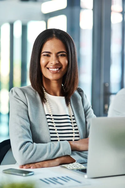 stock image Filled with ambition and potential. Portrait of a confident businesswoman working on a laptop in an office