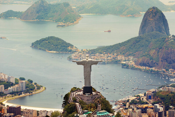 Brazil landscape, city and Christ the Redeemer on hill for tourism, sightseeing and travel destination. Traveling, Rio de Janeiro and aerial view of statue, sculpture and global landmark on mountain.
