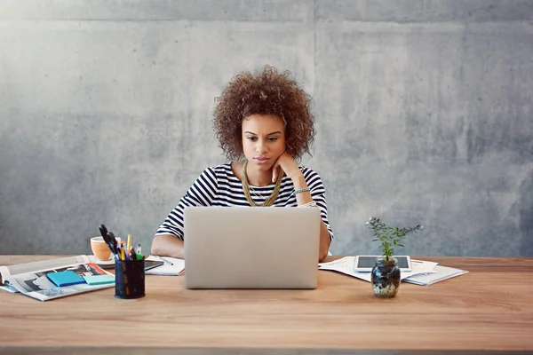 stock image Putting in the hours for success. a young woman working on a laptop at home