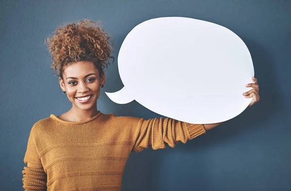 stock image Speak your truth. Studio shot of a young woman holding a speech bubble against a grey background