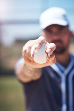 Hand holding baseball, closeup and man for sports, field and training with blurred background in sunshine. Softball player, sport and zoom of ball for training, fitness and workout for competition. clipart