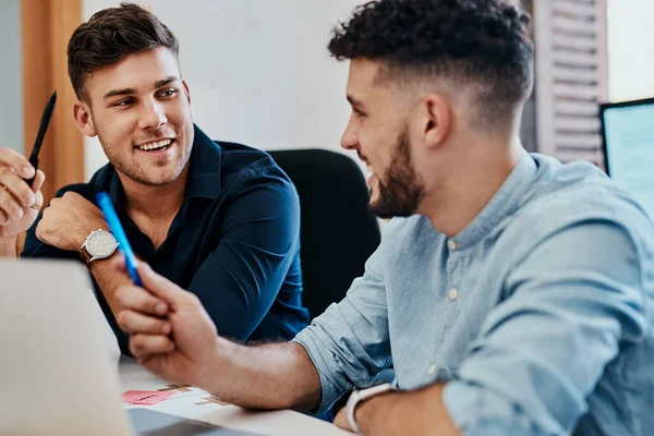 stock image If anyone can make it happen, they will. two young businessmen using a laptop together in a modern office