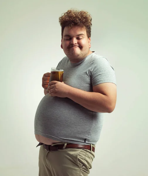 長い一日の後にビールに勝るものはない 太りすぎの男は腹の中でビールとバランスを取りながら — ストック写真