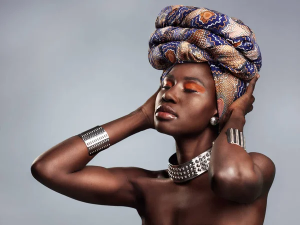 stock image Black woman in traditional turban, fashion and beauty with makeup isolated on studio background. Natural cosmetics, confidence and female model with African head wrap, cosmetic glow and style.