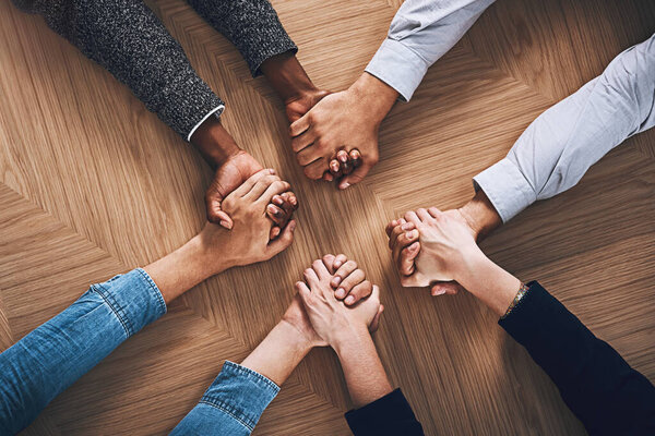 Above, motivation or business people holding hands for support, team building or teamwork in office. Partnership, zoom or employees in group collaboration with diversity or mission for goals together.