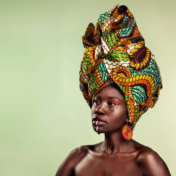 Beauty, black woman and cosmetics with African turban and makeup with mockup. Isolated, green background and young female person thinking with a traditional hair scarf with confidence and culture.