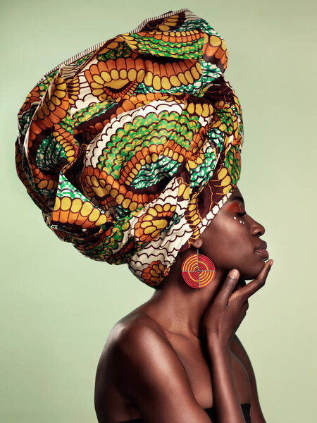 Beauty, profile and black woman in head wrap in studio for culture, glow and cosmetics on green background with space. Makeup, turban and african female model with pride, tradition and confidence.