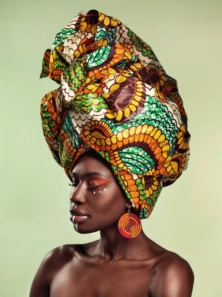 Beauty, black woman and fashion cosmetics with African head wrap and makeup with mockup. Isolated, green background and young female person with a traditional hair scarf with confidence feeling relax.