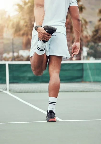Man, hands and stretching legs on tennis court getting ready for match or game in the outdoors. Fit and active male person or sport player in warm up leg stretch for workout, exercise or training.