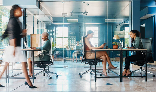 Busy, coworking and business people in the office for work with company diversity at an agency. Blur, corporate and employees in the workplace for professional commitment in an executive career.