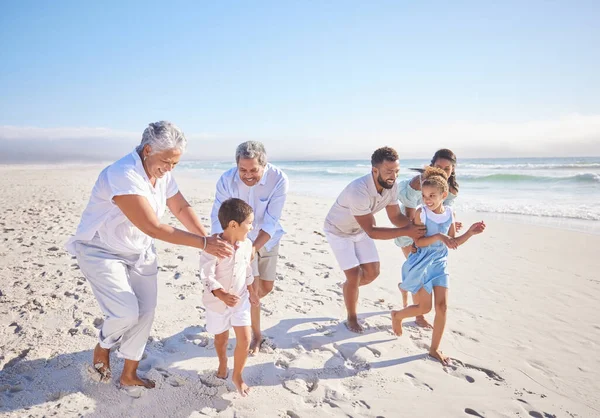 Travel, holiday and big family playing on beach for running and bonding on weekend trip. Happy, excited and children having fun with their grandparents and parents by the ocean on tropical vacation