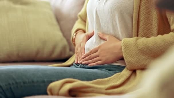 因月经周期 怀孕或腹部抽筋而造成的疼痛 经期及与胃有关的妇女 消化问题和女孩在沙发上抱着肚子治疗子宫内膜异位症 痛症和家里疼痛 — 图库视频影像