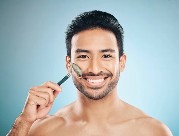 快乐的男人 肖像或面部按摩与玉滚筒 面部产品为健康的皮肤护理工作室背景 与皮肤科化妆品或美容搭配的放松 美容美发或男模微笑 — 图库照片