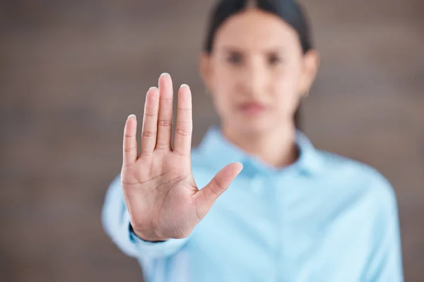 Stop, hand sign and woman with no gesture for sexual harassment and violence in workplace. Business professional, palm and female employee at company with stopping emoji for gender rights at job.