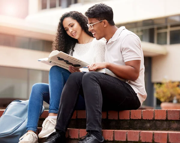 stock image Reading, university and man and woman with book on campus for learning, knowledge and studying. Education, friends and male and female students with textbook for information, research or college.