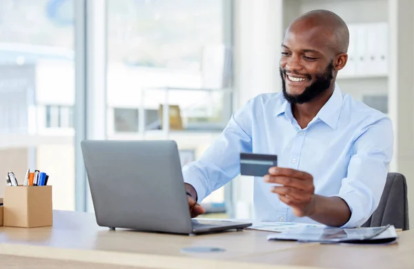 Business, payment and black man with a credit card, laptop and connection with accounting. Male person, customer and employee with a pc, technology and transaction with consumer and online shopping.