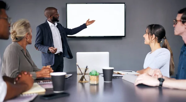 Businessman, coaching and meeting on mockup screen for project management or planning at the office. Black man, coach or business mentor in team presentation or training staff on mock up at workplace.