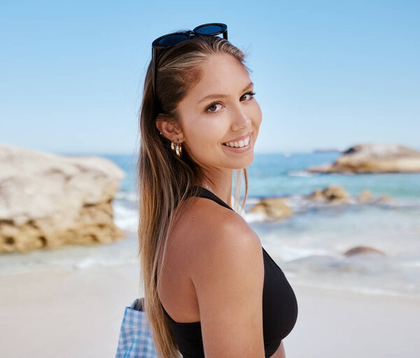 Woman, portrait and smile at beach with travel, summer tropical vacation in Mexico with tourism and adventure. Female person is happy, relax on holiday with journey to the ocean and seaside nature.
